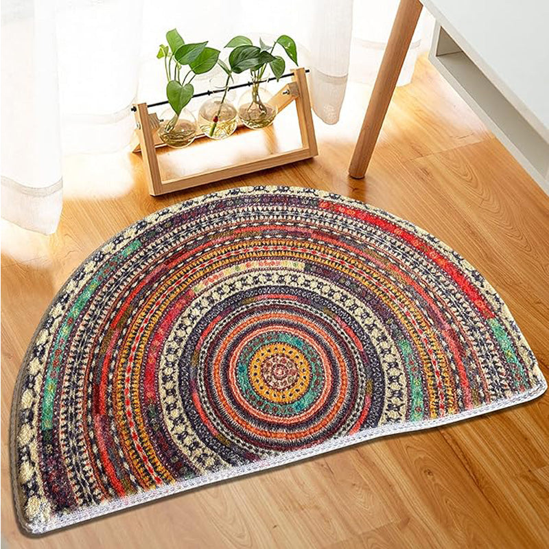 Half-round boho mandala bath mat on a wood floor