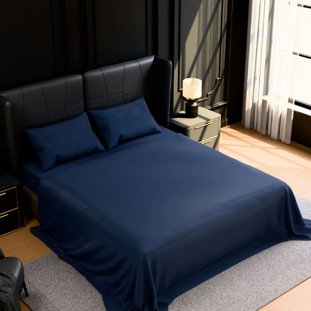 Navy blue brushed microfiber sheet set on a queen bed