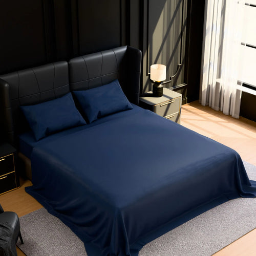 Navy blue brushed microfiber sheet set on a queen bed
